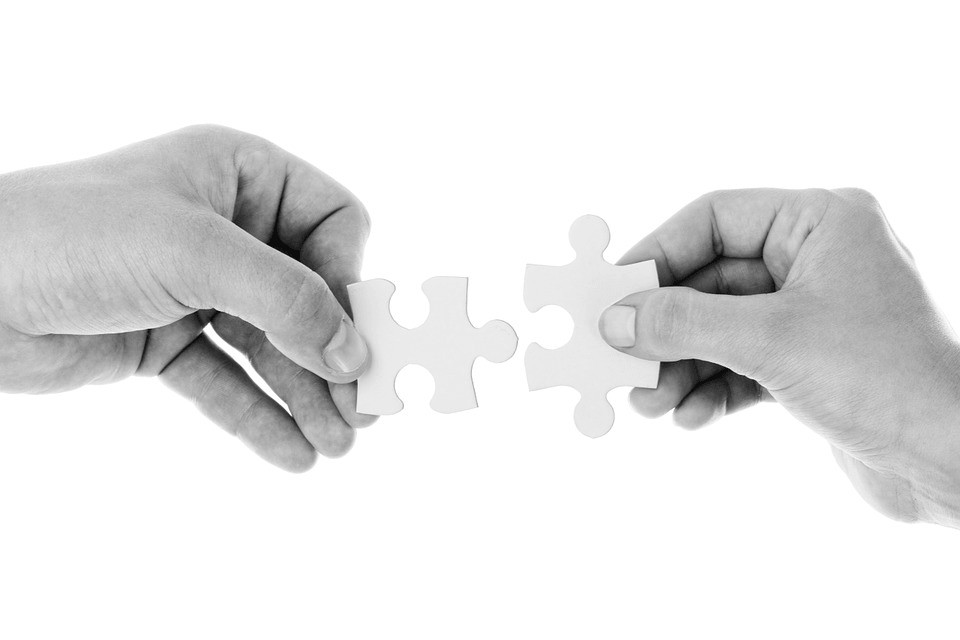 improve email deliverability: two hands solving a puzzle